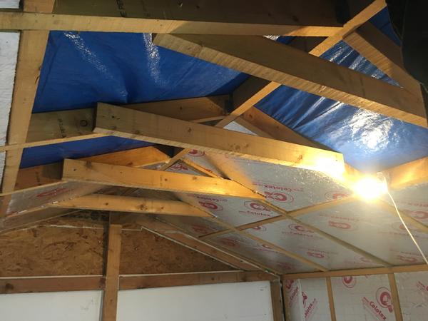 Installation of insulation into the roof apex. The dust falling from the board as they are positioned in place made this an unpleasant job.